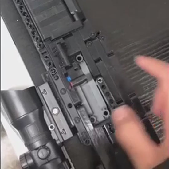Close view of the MK14 Brickblaster mechanism being worked by hand.
