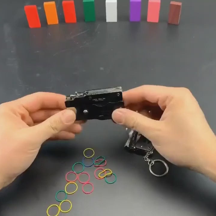 Nano Miniblaster demo: unfolding the black mini blaster, loading rubber bands and operating its firing mechanism.